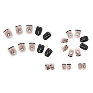 Short black heart press-on nails with minimalist French tip design in glossy finish