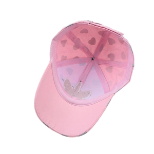 Pink kids baseball cap with unicorn embroidery and heart print lining shown from inside