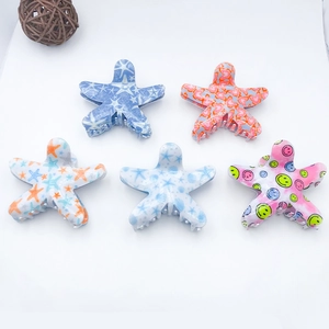 Set of 5 colorful starfish-shaped hair claws with smiley faces and vibrant patterns