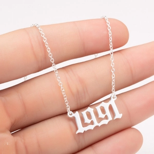 Detailed close-up of 1991 year number pendant in Gothic font on a steel cable chain
