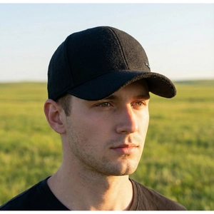 Detail view of winter black wool baseball cap with side ear protection and sport logo