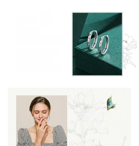 Detail of S925 sterling silver hoop earrings with multicolored rainbow gemstones
