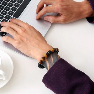 Men's Tiger Eye and Agate beaded bracelet with a gold letter Y charm on a wrist