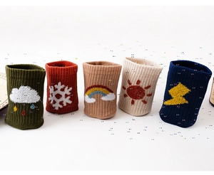Set of five combed cotton socks with weather motifs and ribbed cuffs on a white background