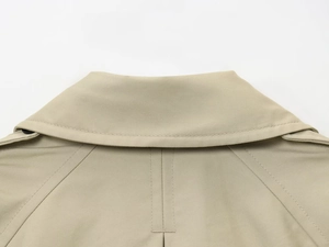 Detailed macro view of khaki trench coat collar and twill fabric texture details