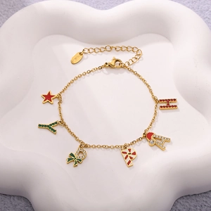 Close-up of stainless steel gold bracelet with star and letter enamel Christmas charms