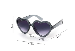 Detailed view of heart-shaped sunglasses with silver glitter frame and size measurements