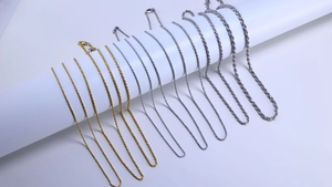 Comparison of various gold and silver rope chain necklaces in different widths on display