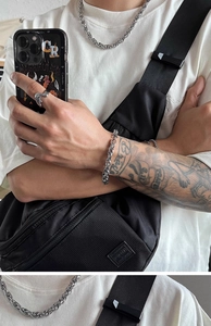 Close-up of hip hop style silver titanium steel bracelet and jewelry worn by a male model