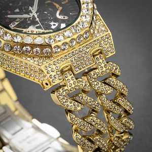 Close-up of luxury gold iced-out watch with hollow mechanical dial and diamond Cuban link band
