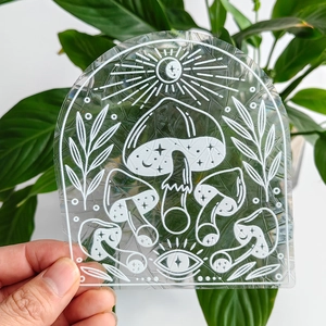 Rainbow suncatcher window film detail with mushroom and moon patterns in arch shape