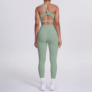Rear view of a sage green one-shoulder yoga set with cutout back and high-waist leggings