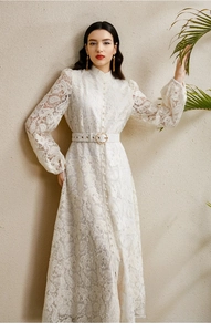 Close-up of white palace style lace dress with stand collar and pearl buttons detail
