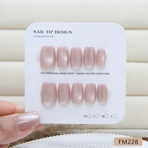 Handmade pink cat eye press-on nails set with pearlescent finish on display card