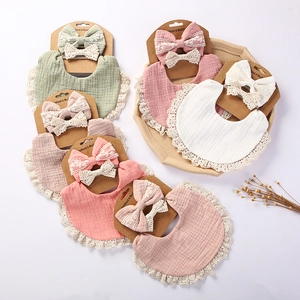 Detail of baby muslin bib and headband sets with lace trim in multiple pastel colors