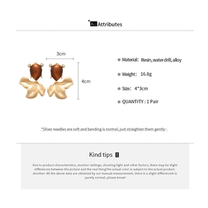 Detailed view of resin goldfish earrings with dimensions 4x3cm and 16.8g weight specs