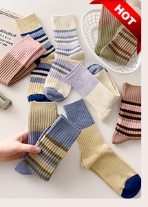 Close-up of assorted ribbed cotton crew socks in pastel and earth tones displayed in a basket