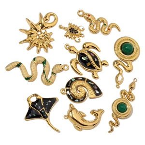 Collection of golden sea life and animal pendants with enamel and shell textures