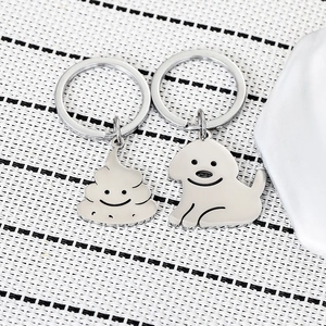 Funny stainless steel dog and poop shape keychains on woven mat texture