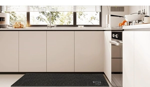 Detail of dark gray kitchen mat featuring non-slip texture and modern cutlery design