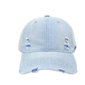 Vintage light blue denim baseball cap with distressed rip details and street style look
