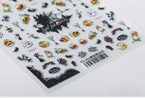 Macro shot of TS-191 Halloween nail stickers featuring pumpkins and ghosts on white surface