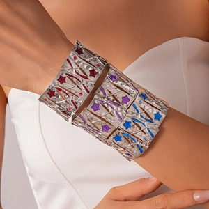Detail of silver stretch bracelet featuring colorful red, purple and blue star charms
