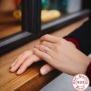 Close-up of a luxury 925 sterling silver ring with a large solitaire crystal on a hand