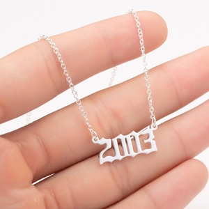 Detail view of silver stainless steel 2003 year number pendant in Gothic font