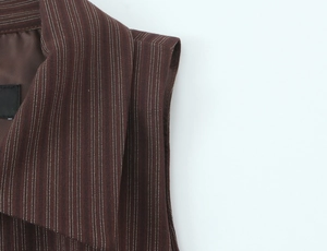 Detailed view of brown striped vest neckline with high-quality woven fabric texture