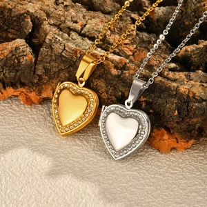 Polished gold and silver heart locket necklaces with crystal inlay on natural bark