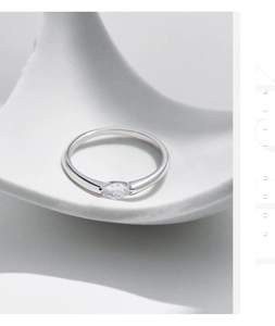 Detailed view of silver s925 ring with marquise cut gemstone on white ceramic