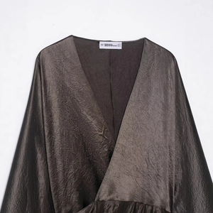 Elegant deep bronze V-neck satin blouse with metallic texture and natural crinkle effect