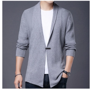 Detail of light grey men's knitted cardigan showing fabric texture and black tag label