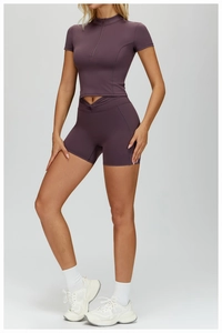 Detail of high-waisted gym shorts with crossover waistband and purple seamless fabric