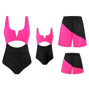 Flat lay of matching family swimwear set in hot pink and black with cutout details