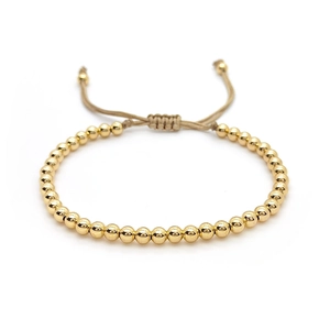 Stackable gold beaded bracelet with freshwater pearls and adjustable woven cord