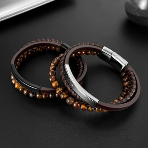 Detail view of multi-layer tiger eye stone beads and braided leather bracelets for men
