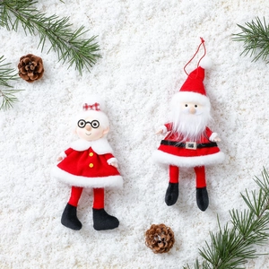 Christmas plush dolls of Santa and Mrs. Claus hanging ornaments with pine cones