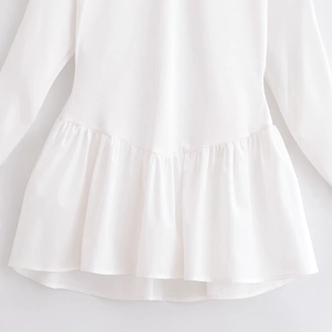 Elegant white long sleeve top with ruffle hem and mixed texture fabric detailing