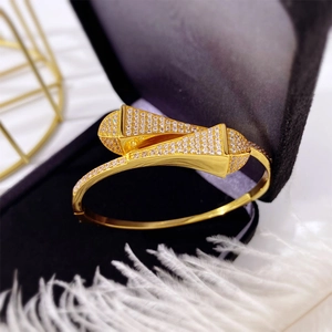 Elegant gold-plated double-row crystal pave open bangle in a black jewelry box