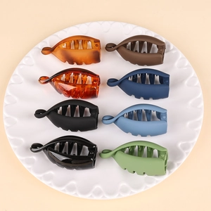 Set of 8 colorful matte banana hair clips for ponytail styling in an elegant white tray