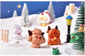 Detailed view of Christmas miniature resin reindeer and puppy figures in a snowy scene