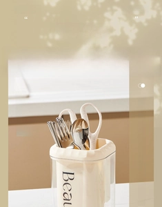 Macro shot of cream-style double-layer kitchen utensil holder with cutlery