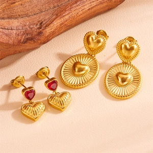 Vintage gold heart earrings with red crystal and textured radial starburst medals
