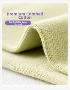 Close-up of light green combed cotton knit fabric texture with fine stitched details