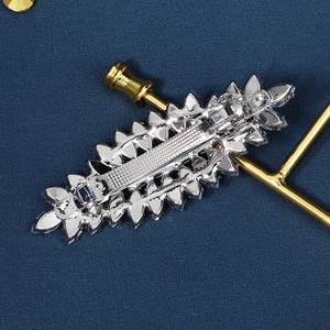 Detailed macro view of silver alloy spring hair clip with sparkling rhinestone petals
