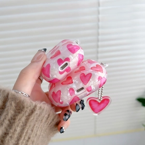 Detail of marble shell pattern AirPods cases with heart charms in pink and white