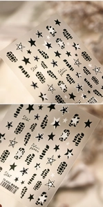 Detail shot of TS-4262 nail stickers featuring black stars and snake pattern textures
