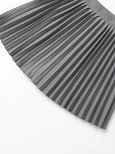 Detailed close-up showing the fine woven texture and accordion pleats of a grey midi skirt